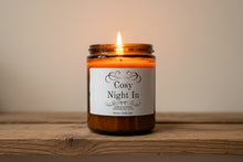 Load image into Gallery viewer, Candle labeled 'Cosy Night In' on a wooden surface with a neutral background