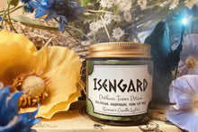 Load image into Gallery viewer, Candle labeled 'Isengard' surrounded by flowers and a blurred figure holding a lantern.